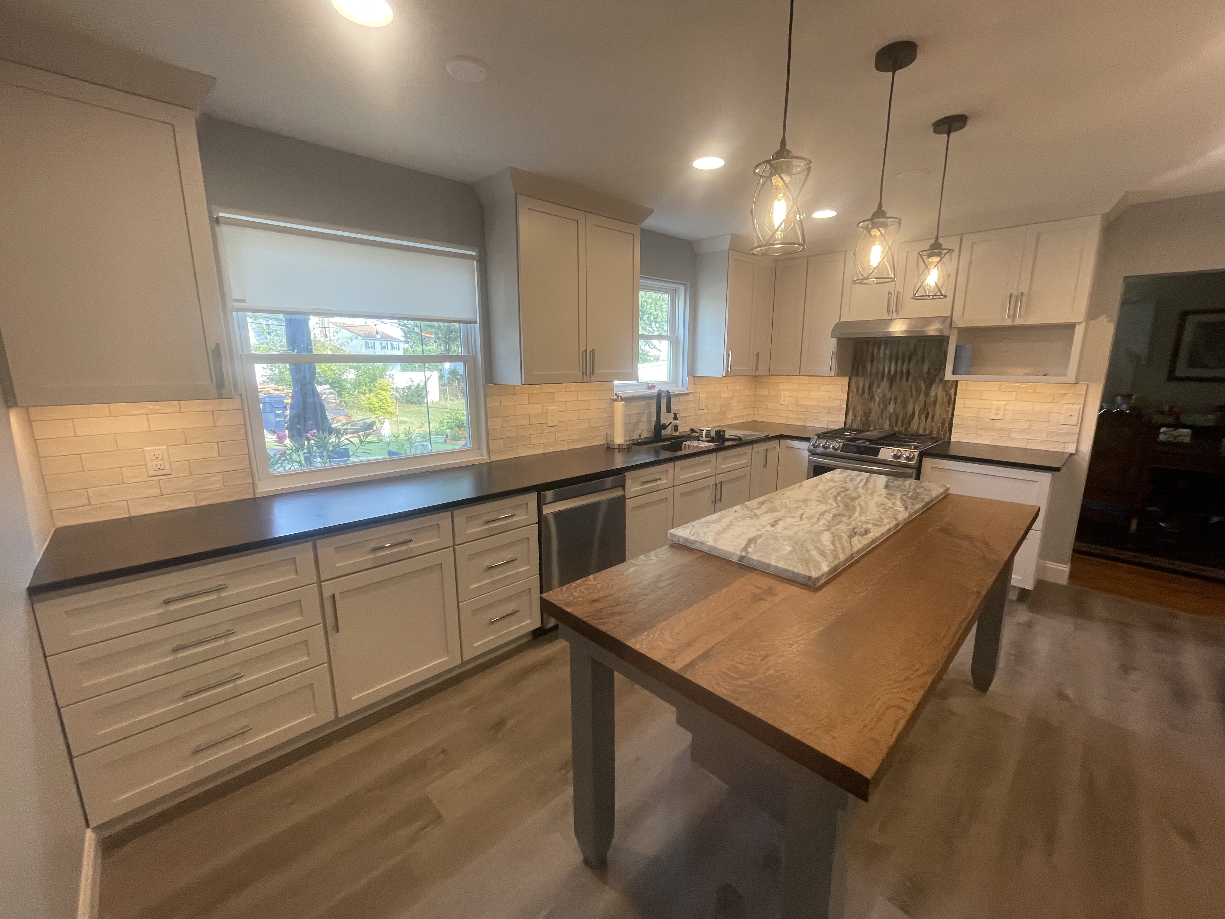 Completed Delaware Renovation kitchen with a wood island and light cabinetry