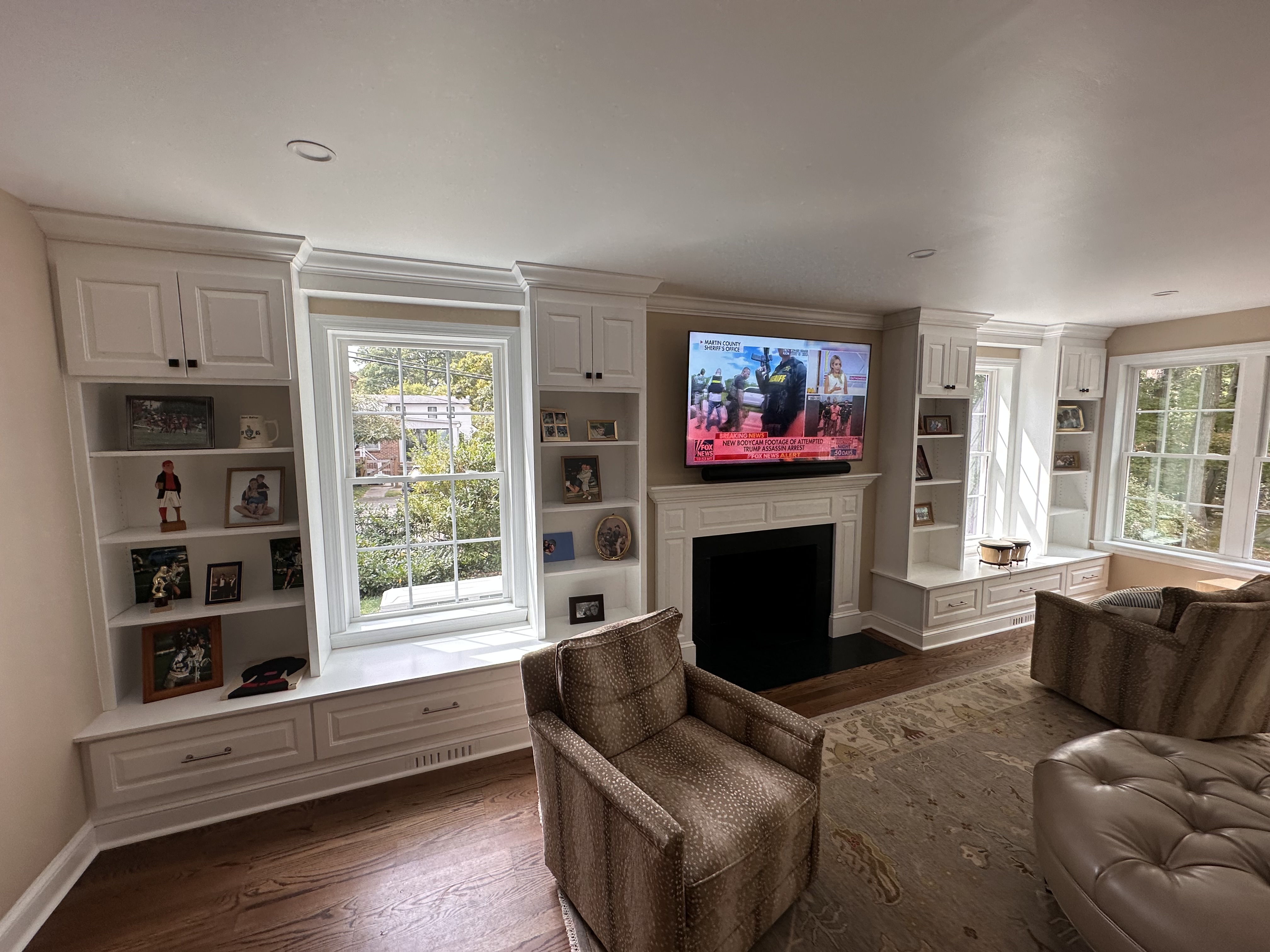 Completed living room renovation with built-in cabinetry and fireplace